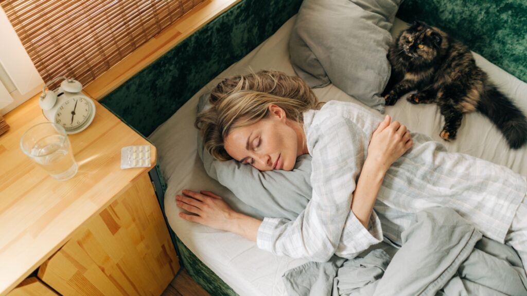 woman sleeping with her cat